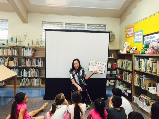 1653754_web1_Librarian-Cindy-Chock-reading-aloud-to-Kealakehe-Elem.-students-at-the--Jan.-29-ABC-Read-To-Me.201521192122685.jpg