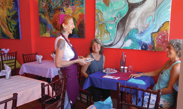 5410146_web1_Susan-laughs-with-friends-in-her-colorful-new-Sweet-Potato-Kitchen-location-in-Hawi-Tuesday2017525164539766.jpg