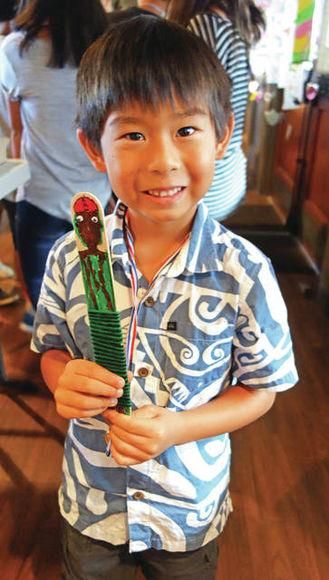 5697475_web1_Seven-year-old-Cameron-Miure-proudly-shares-his-popsicle-stick-artwork-before-the-show2017726131744669.jpg